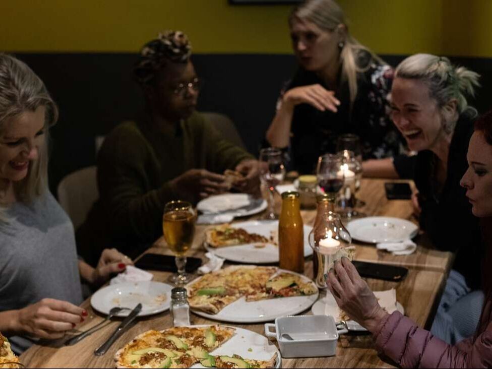 Picture of group of friends gathering at Picola Italian enjoying Pizza